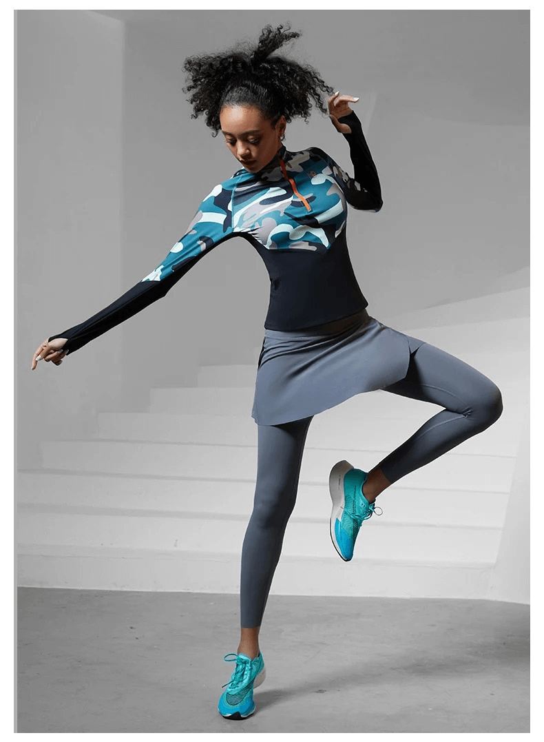 Woman wearing women's camo print long sleeve sport shirt SF2019 performing a high kick, showing athletic movement and style.
